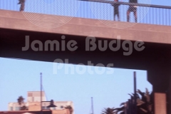 INLINE SKATER RAIL GRINDS  IN FRONT OF STARTLED PEDESTRIANS ON PIER 
© Jamie Budge, all rights reserved.