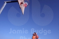 KID LOOKS AT HOOP FROM STOOL © Jamie Budge