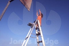 KID SHOOTS HOOP FROM LADDER © Jamie Budge, all rights reserved.