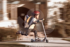 SCOOTER KID BY SCHOOL AND SCHOOL SIGN © Jamie Budge, all rights reserved