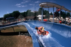 © Jamie Budge, all rights reserved.
BRIAN LUND "SURFS" THE ENTIRE 400 FOOT LENGTH OF THE AQUA SLIDE AT "WET "N" WILD" WATER PARK.
No Rights Implied by possession of this image.     Contact:
Jamie Budge (310) 453-4808  jamiebudge@windskate.com