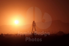 © Jamie Budge, All Rights Reserved.
THE MAN STANDS SILHOUETTED AGAINST THE SUNSET ON THE BLACK ROCK DESERT.
NO RIGHTS Implied by posession of this CD.  Contact:
jamiebudge@windskate.com    (310) 453-4808